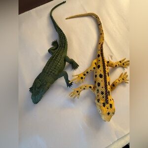 yellow and black spotted reptile figurine and a green alligator or crocodile
